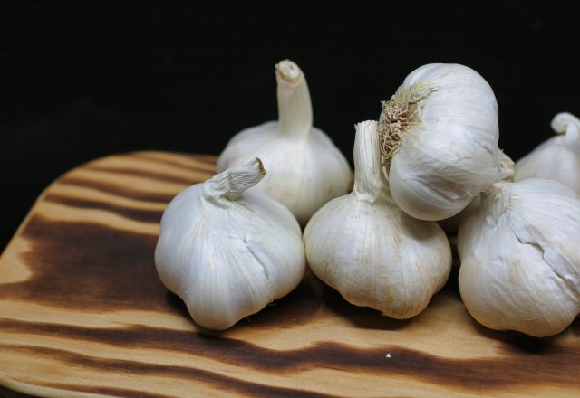 garlic bulbs on brown surface