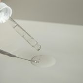 Oil dropper with a clear liquid on a white background