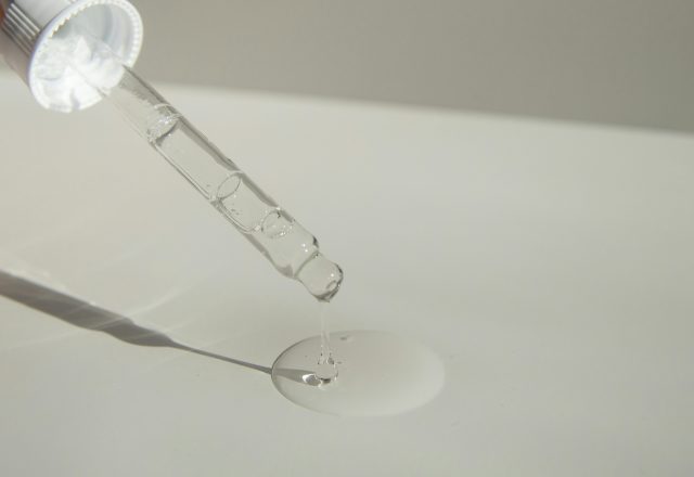 Oil dropper with a clear liquid on a white background