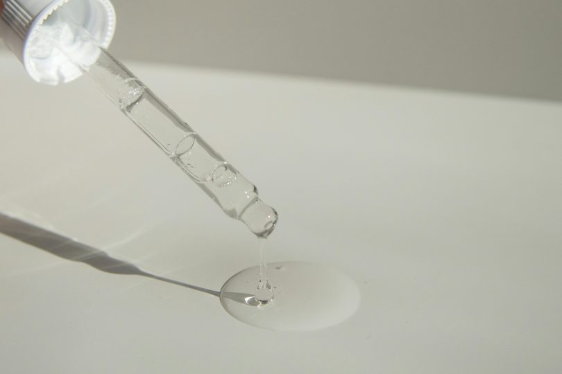 Oil dropper with a clear liquid on a white background